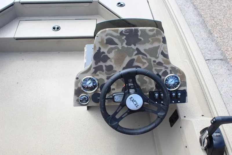 Slide: The Image of 2026 Excel Bolt 183 boat dashboard with camo design and steering wheel. - 7