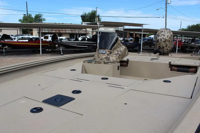 Slide: The Image of 2026 Excel Bolt 183 boat with camouflage seats, parked in a lot with other boats. - 8