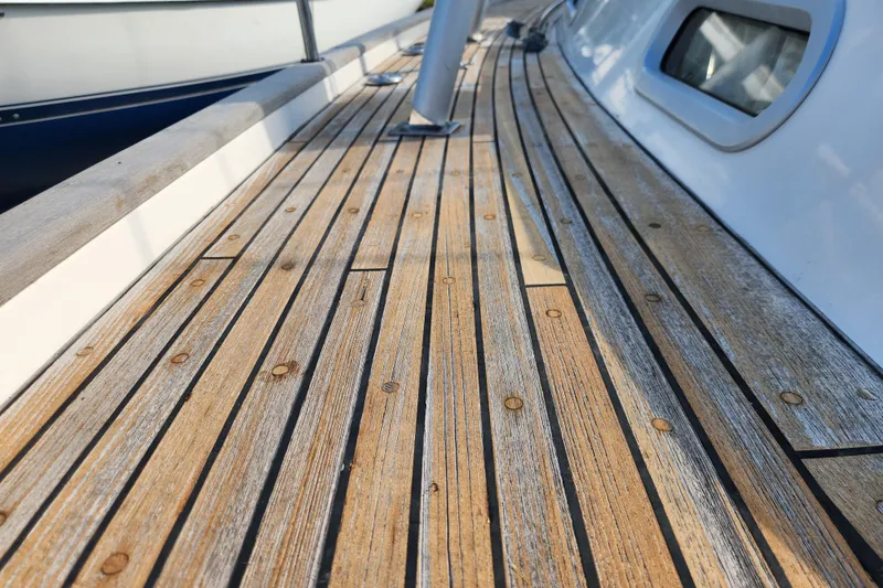 Slide: The Image of Teak deck of 2007 Hallberg-Rassy 37 sailboat, showcasing elegant wood grain. - 11