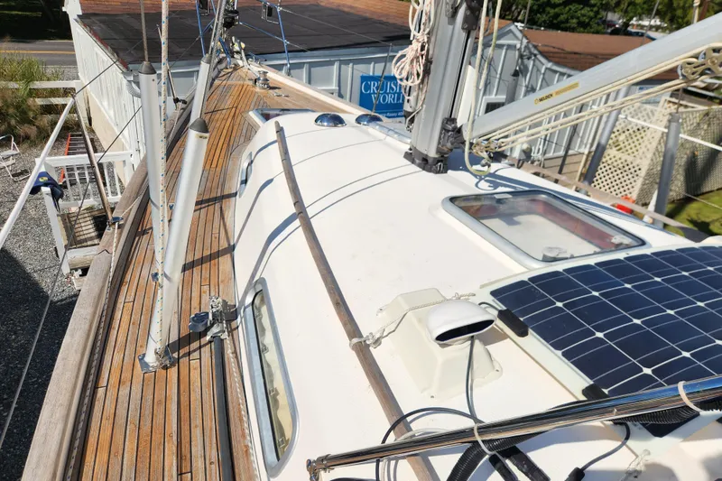 Slide: The Image of 2007 Hallberg-Rassy 37 sailboat deck with solar panel and wooden finish. - 12