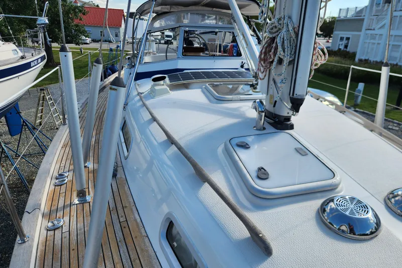 Slide: The Image of 2007 Hallberg-Rassy 37 sailboat deck with rigging and hatch, docked outdoors. - 14
