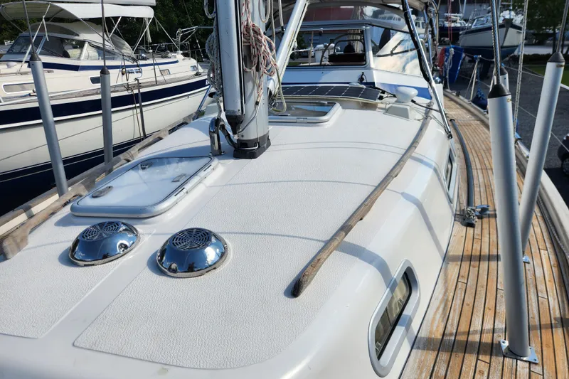 Slide: The Image of 2007 Hallberg-Rassy 37 sailboat deck with wooden accents and chrome details. - 15