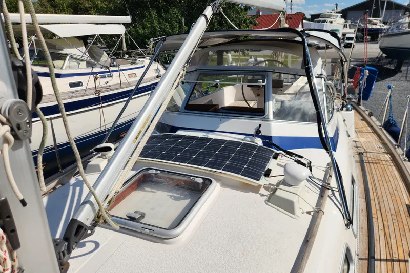 Slide: The Image of 2007 Hallberg-Rassy 37 sailboat with solar panel on deck, docked in marina. - 17