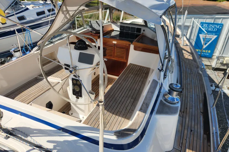 Slide: The Image of 2007 Hallberg-Rassy 37 sailboat cockpit with wooden deck and steering wheel. - 18