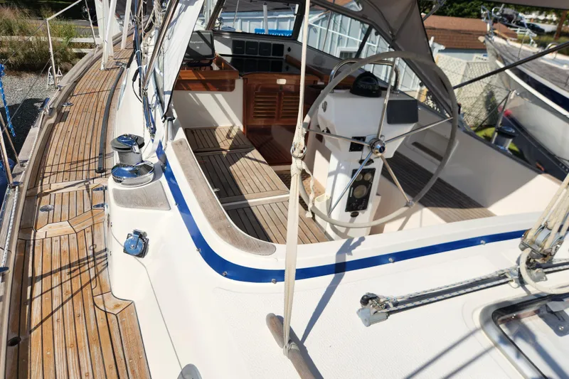 Slide: The Image of 2007 Hallberg-Rassy 37 sailboat cockpit with wooden deck and steering wheel. - 19