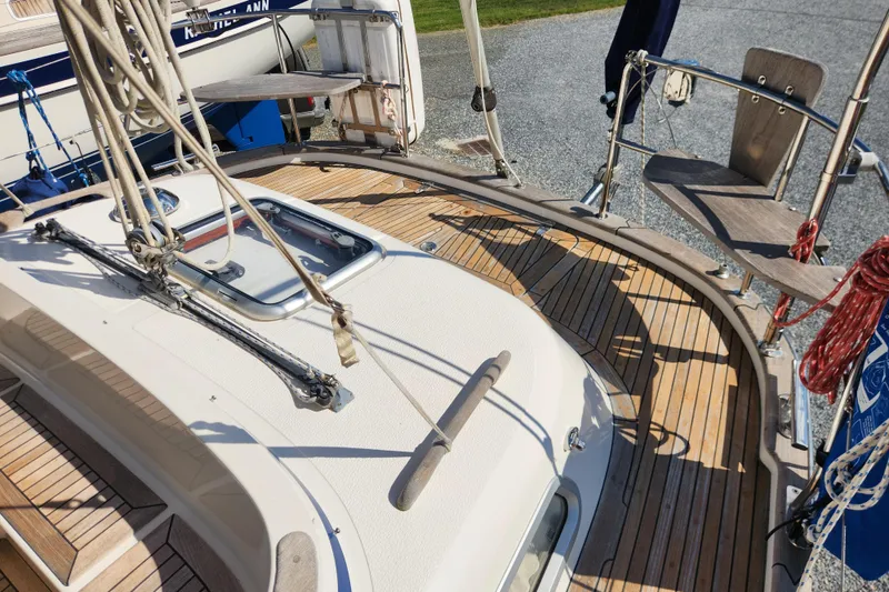 Slide: The Image of Deck view of a 2007 Hallberg-Rassy 37 sailboat with teak wood finish. - 21