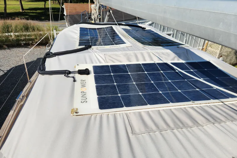 Slide: The Image of Solar panels on a 2007 Hallberg-Rassy 37 sailboat, harnessing renewable energy. - 22