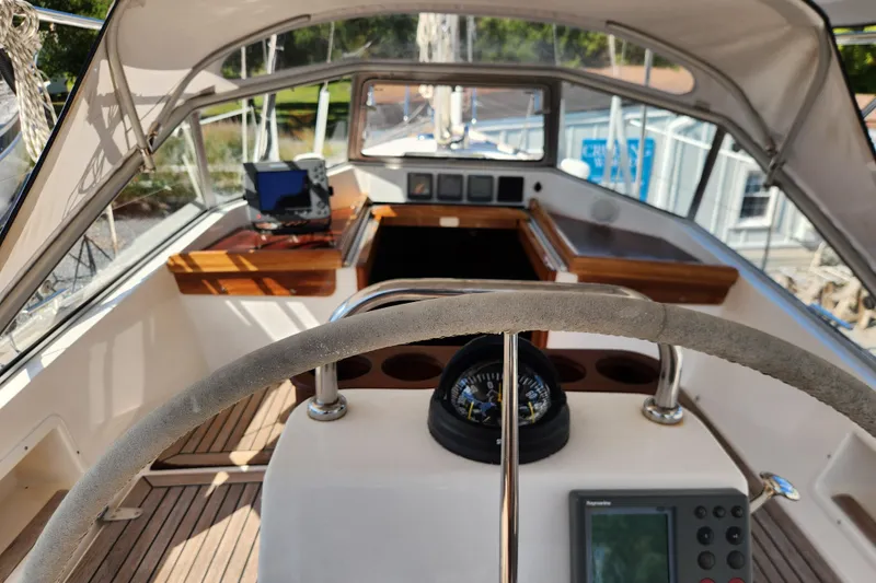Slide: The Image of Cockpit of 2007 Hallberg-Rassy 37 sailboat with steering wheel and navigation equipment. - 23