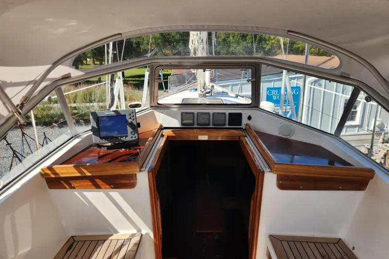 Slide: The Image of Cockpit of 2007 Hallberg-Rassy 37 sailboat with navigation equipment and wooden trim. - 24