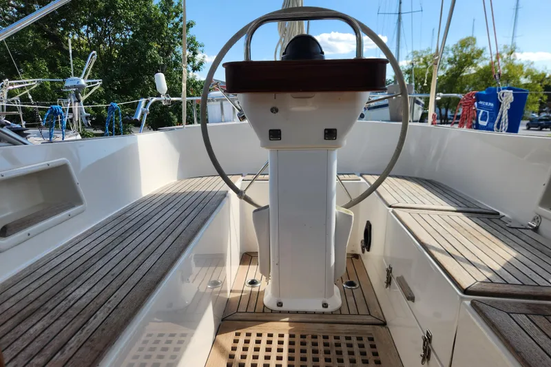 Slide: The Image of Cockpit of 2007 Hallberg-Rassy 37 sailboat with wooden seating and steering wheel. - 25
