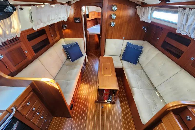 Slide: The Image of Interior of 2007 Hallberg-Rassy 37 yacht with wooden finish and beige seating. - 26