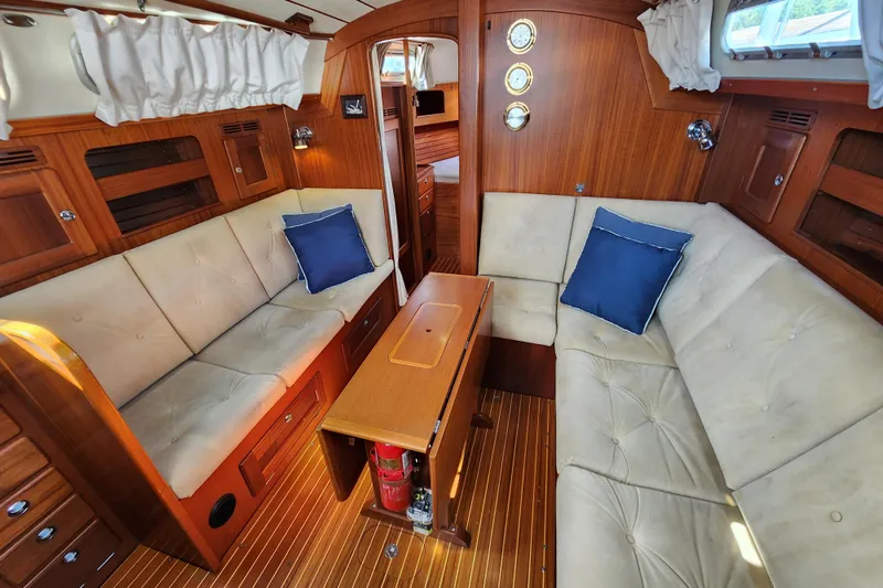 Slide: The Image of Luxurious 2007 Hallberg-Rassy 37 yacht interior with plush seating and elegant wood finish. - 27