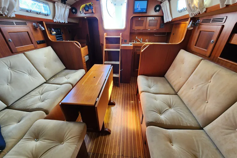 Slide: The Image of Luxurious interior of 2007 Hallberg-Rassy 37 yacht with plush seating and wooden finishes. - 30