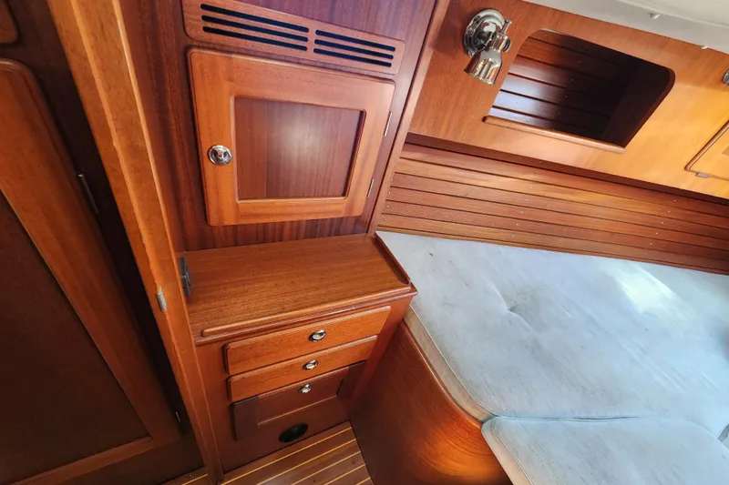 Slide: The Image of Interior of 2007 Hallberg-Rassy 37 yacht with wooden cabinetry and cushioned seating. - 38