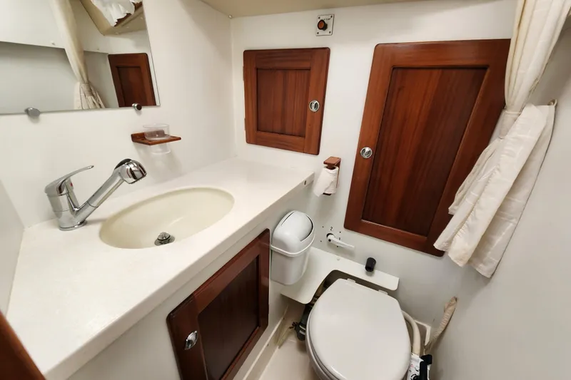 Slide: The Image of Bathroom interior of a 2007 Hallberg-Rassy 37 yacht, featuring wooden cabinets and modern fixtures. - 39