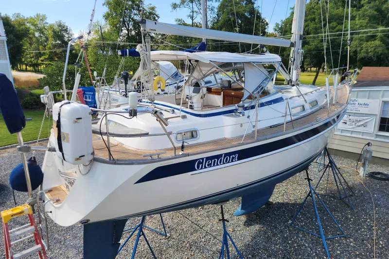 Slide: The Image of 2007 Hallberg-Rassy 37 sailboat on stands, named Glendora, in a yard setting. - 4