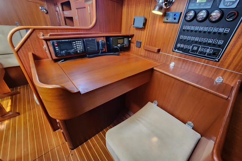 Slide: The Image of Navigation station of 2007 Hallberg-Rassy 37 yacht with control panel and radio equipment. - 40