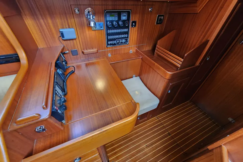 Slide: The Image of Interior of 2007 Hallberg-Rassy 37 yacht with wooden navigation station and control panel. - 41