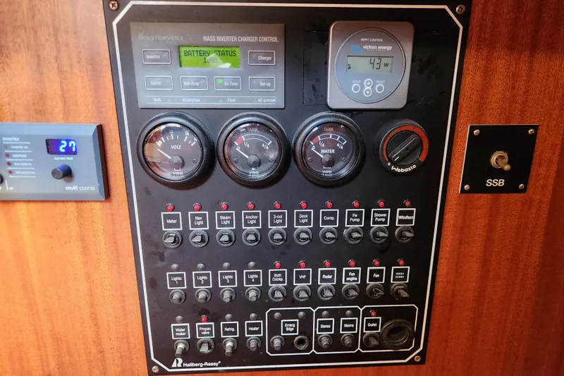 Slide: The Image of Control panel of a 2007 Hallberg-Rassy 37 yacht with various gauges and switches. - 43