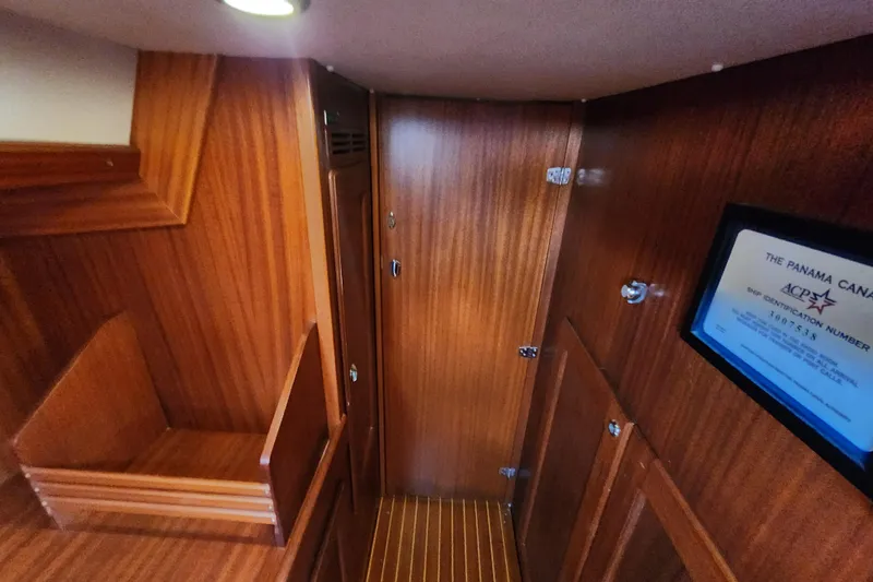 Slide: The Image of Interior of 2007 Hallberg-Rassy 37 yacht with wooden paneling and Panama Canal certificate. - 44