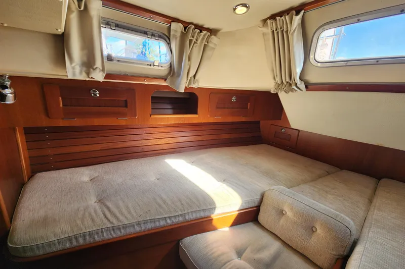 Slide: The Image of Cozy cabin interior of 2007 Hallberg-Rassy 37 sailboat with wooden accents and cushioned seating. - 46