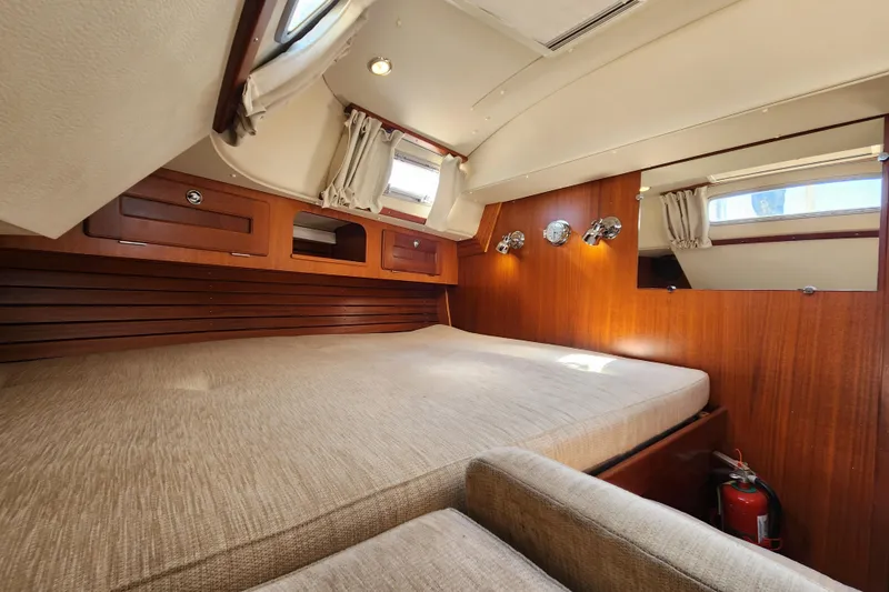 Slide: The Image of Interior of 2007 Hallberg-Rassy 37 yacht cabin with wooden finish and cozy bed. - 47