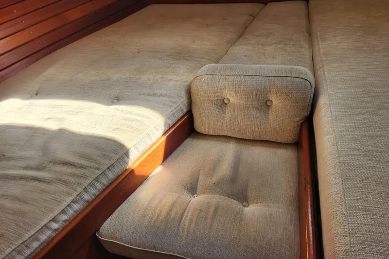 Slide: The Image of Interior of 2007 Hallberg-Rassy 37 yacht with beige cushioned seating. - 48