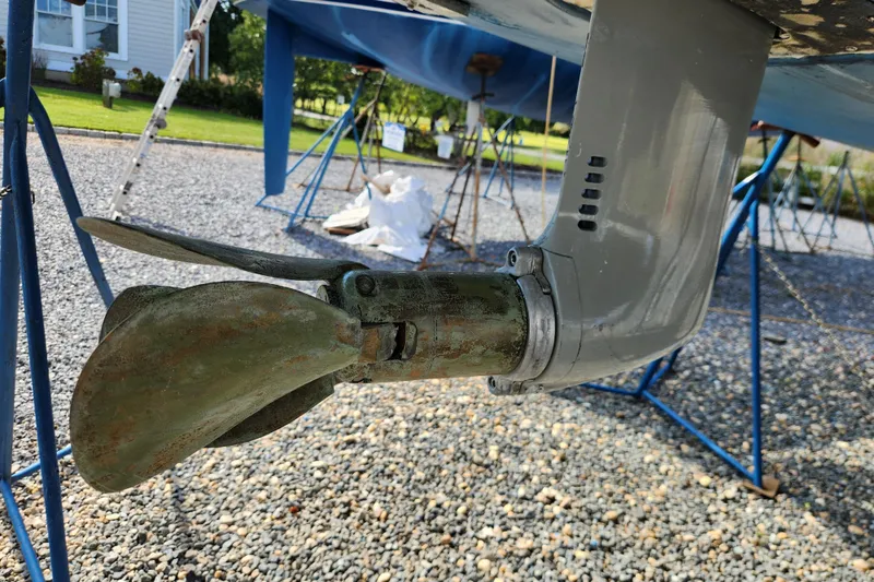 Slide: The Image of Close-up of a 2007 Hallberg-Rassy 37 sailboat propeller and rudder on a gravel surface. - 50