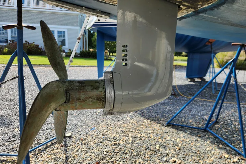 Slide: The Image of Close-up of a 2007 Hallberg-Rassy 37 sailboat propeller and rudder on a gravel surface. - 51