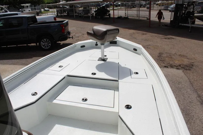 Slide: The Image of 2026 Excel Bay Pro Elite 230 boat deck with seating and storage compartments. - 11