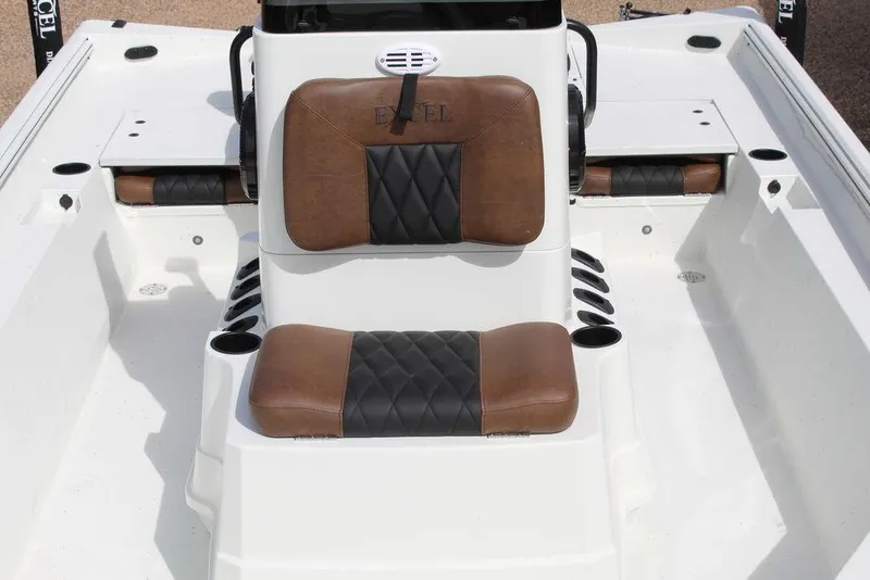 Slide: The Image of 2026 Excel Bay Pro Elite 230 boat interior with brown and black cushioned seating. - 12