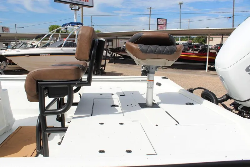Slide: The Image of 2026 Excel Bay Pro Elite 230 boat with brown seating and white deck. - 15