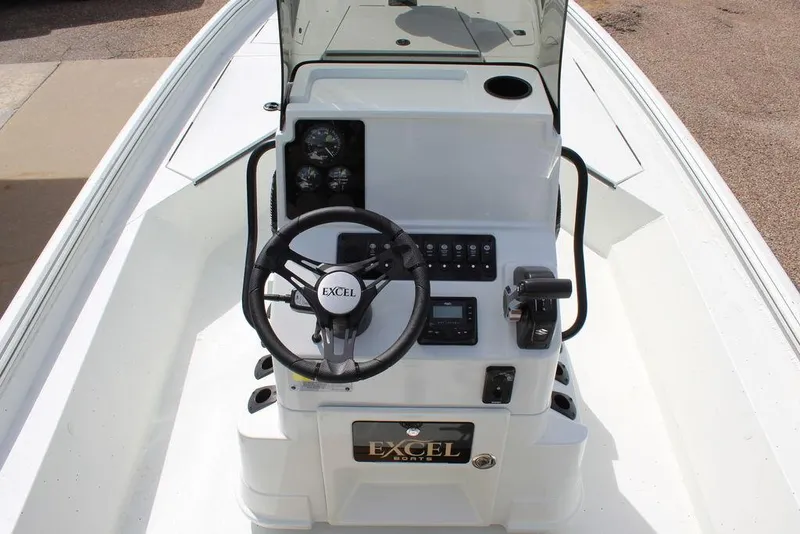 Slide: The Image of 2026 Excel Bay Pro Elite 230 boat console with steering wheel and controls. - 19