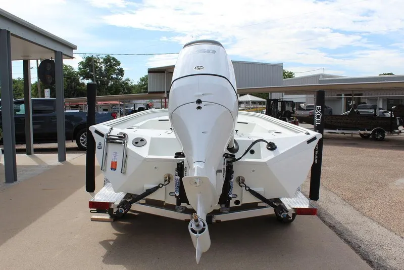 Slide: The Image of 2026 Excel Bay Pro Elite 230 boat, rear view, parked on trailer in outdoor setting. - 5