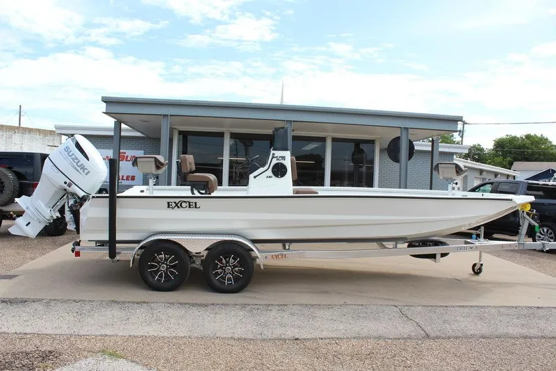 Slide: The Image of 2026 Excel Bay Pro Elite 230 boat on trailer, parked outside dealership. - 7
