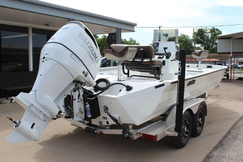 Slide: The Image of 2026 Excel Bay Pro Elite 230 boat with Suzuki outboard motor on trailer. - 8