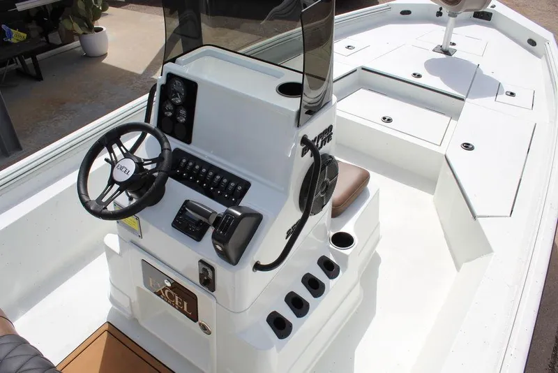 Slide: The Image of 2026 Excel Bay Pro Elite 230 boat interior with steering console and seating. - 9