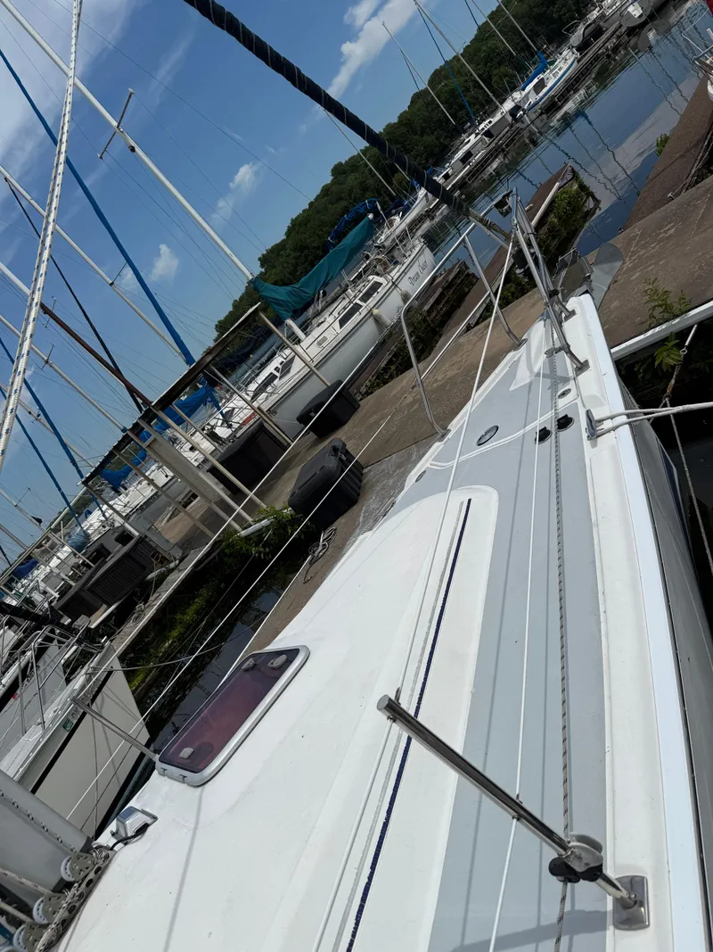 Slide: The Image of Sailboat docked in marina, Hunter 33 model, 2005, with clear blue sky. - 16