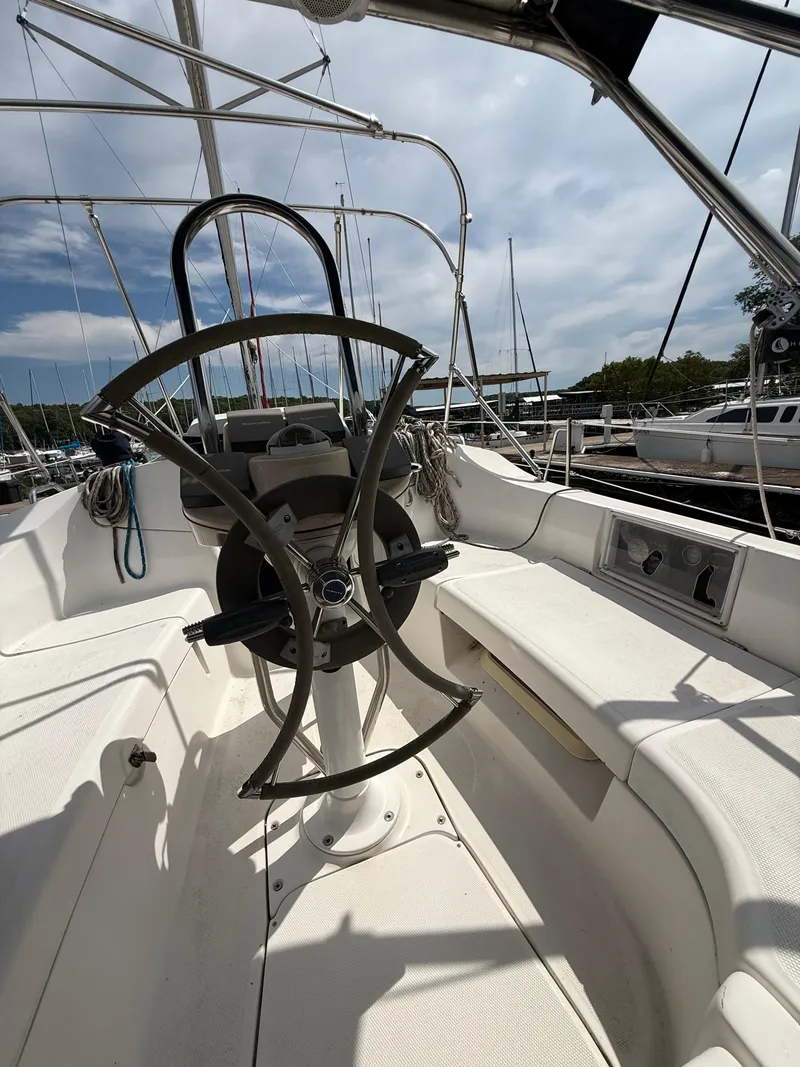 Slide: The Image of Cockpit of a 2005 Hunter 33 sailboat with steering wheel and seating. - 3