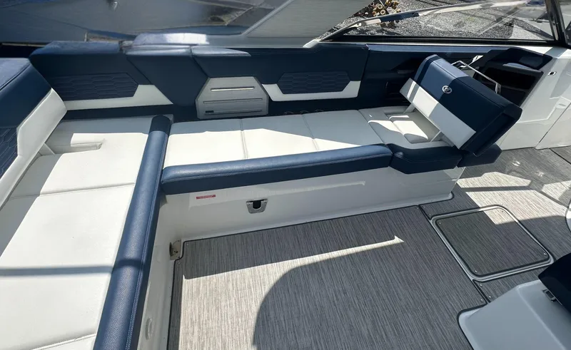 Slide: The Image of 2022 Cobalt A29 boat interior with blue and white seating, modern design. - 14
