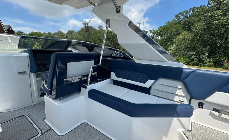 Slide: The Image of 2022 Cobalt A29 boat interior with blue and white seating, modern design. - 15