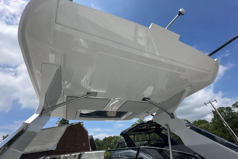 Slide: The Image of 2022 Cobalt A29 boat with sleek design and modern features, under a clear blue sky. - 16