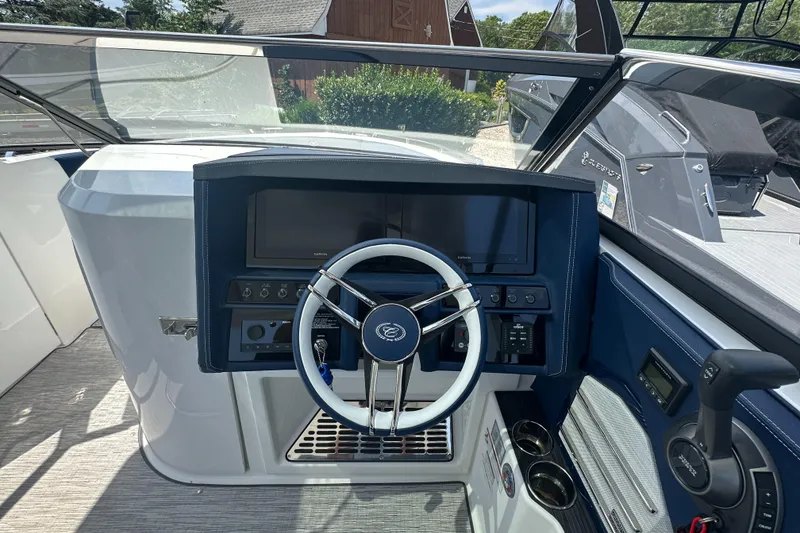 Slide: The Image of 2022 Cobalt A29 boat dashboard with steering wheel and control panel. - 18