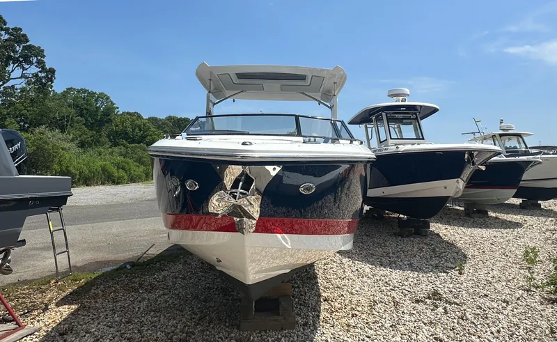 Slide: The Image of 2022 Cobalt A29 boat on display, surrounded by other boats, under a clear blue sky. - 5