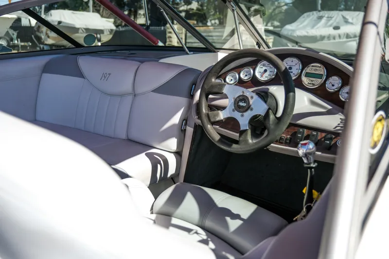 Slide: The Image of Interior of a 2002 MasterCraft ProStar 197 boat, featuring steering wheel and dashboard. - 7