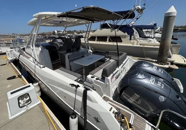 Slide: The Image of 2023 Jeanneau Leader 9.0 WA boat docked, featuring twin Yamaha engines and spacious seating area. - 10
