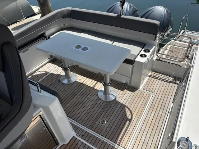 Slide: The Image of 2023 Jeanneau Leader 9.0 WA boat deck with seating and table, featuring sleek design. - 12