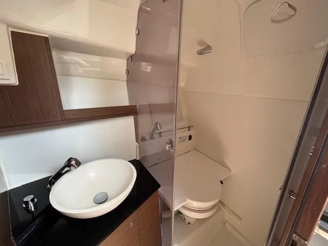 Slide: The Image of 2023 Jeanneau Leader 9.0 WA boat bathroom with modern sink and toilet. - 24
