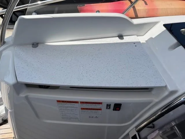 Slide: The Image of 2023 Jeanneau Leader 9.0 WA boat dashboard with white panel and warning labels. - 27