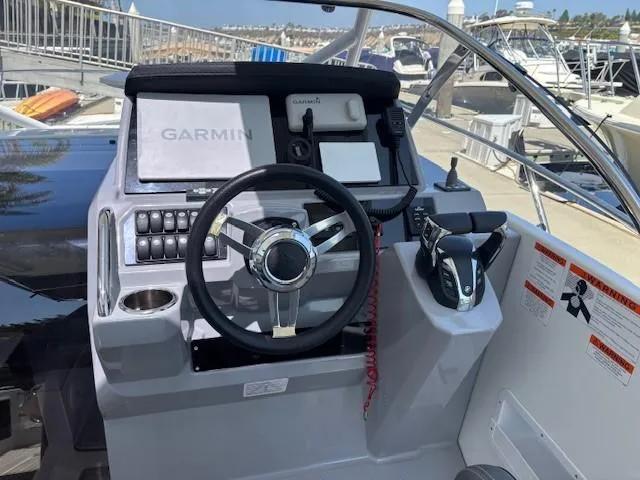 Slide: The Image of 2023 Jeanneau Leader 9.0 WA helm with Garmin navigation system and modern controls. - 29
